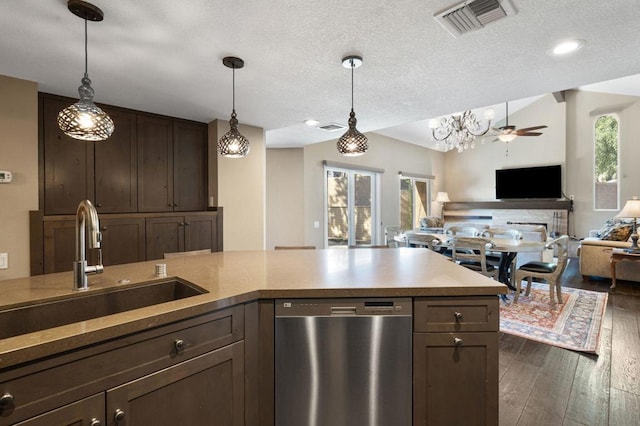 kitchen with plenty of natural light, decorative light fixtures, dishwasher, and sink