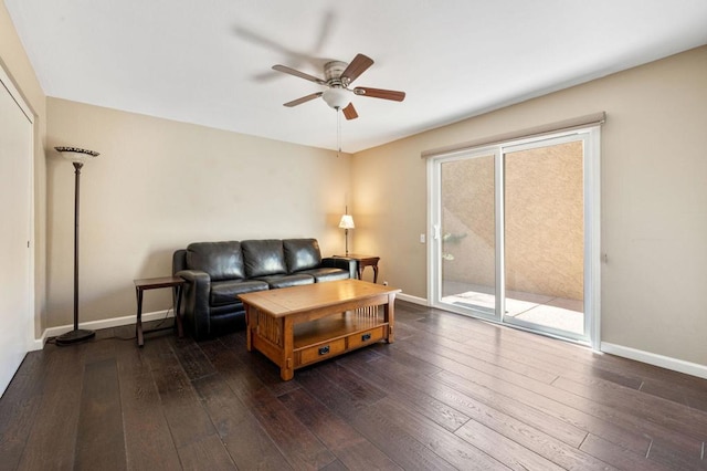 living room featuring ceiling fan and dark hardwood / wood-style floors