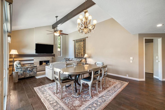 dining room with dark wood-type flooring, ceiling fan, a premium fireplace, and lofted ceiling with beams