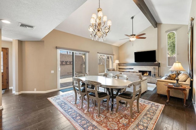 dining room featuring beamed ceiling, ceiling fan, dark wood-type flooring, and a textured ceiling