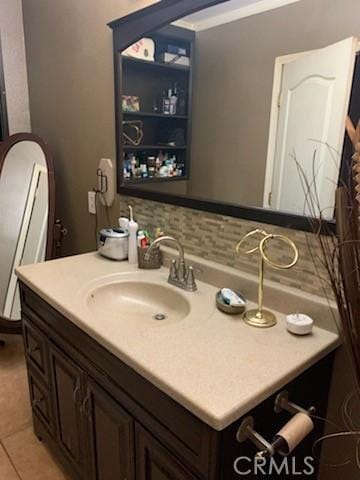 bathroom featuring tile patterned floors, vanity, and decorative backsplash