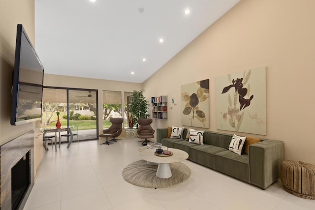 living room with light tile patterned floors and high vaulted ceiling