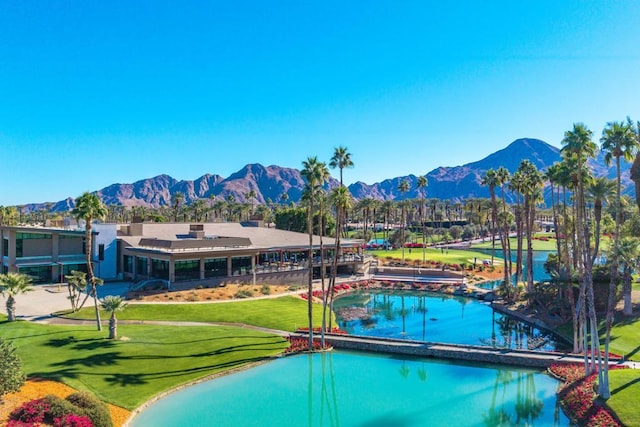 view of pool featuring a lawn and a mountain view