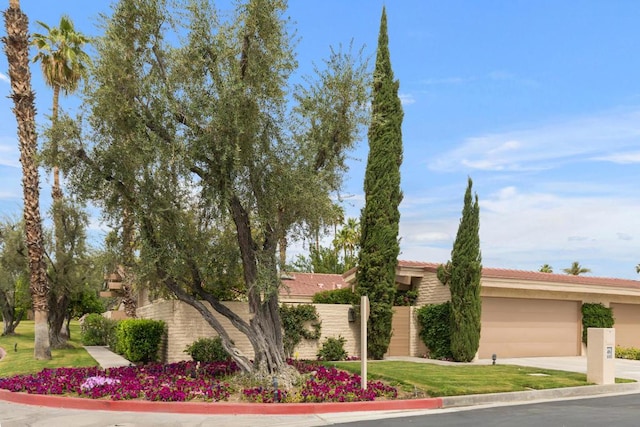 view of front of home with a front lawn and a garage