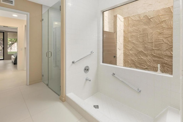 bathroom with tile patterned floors and a shower with shower door