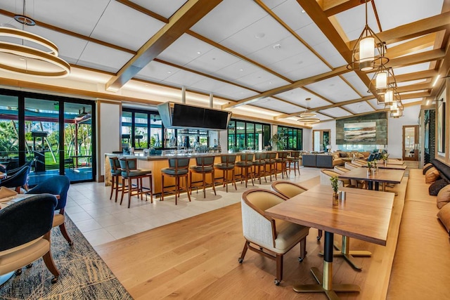 dining room featuring light hardwood / wood-style flooring and coffered ceiling