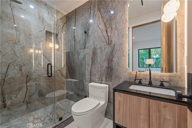 bathroom featuring toilet, vanity, tile walls, and walk in shower