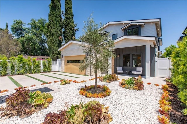 contemporary home featuring covered porch and a garage