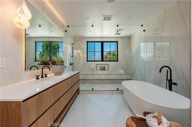 bathroom with tile walls, vanity, and shower with separate bathtub