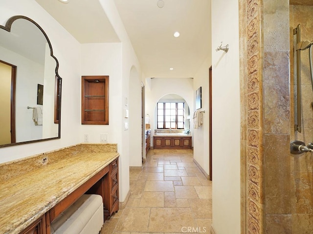 bathroom with walk in shower and vanity