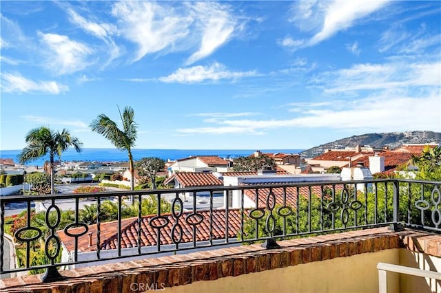 balcony featuring a water view