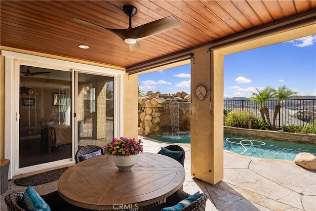 sunroom featuring wooden ceiling, ceiling fan, and a swimming pool