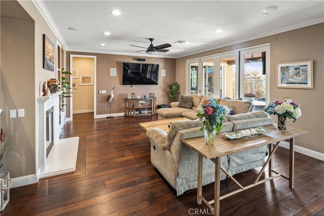 living room featuring ornamental molding, ceiling fan, and dark wood-type flooring