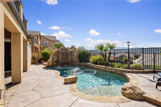 view of swimming pool with a patio and pool water feature