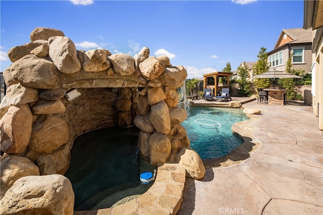 view of swimming pool featuring a gazebo and a patio area