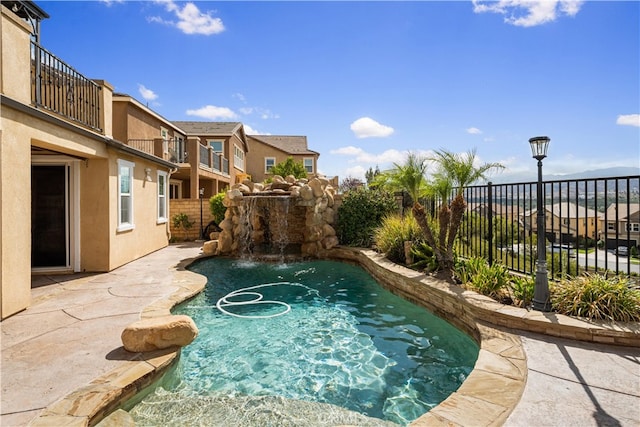 view of pool with pool water feature