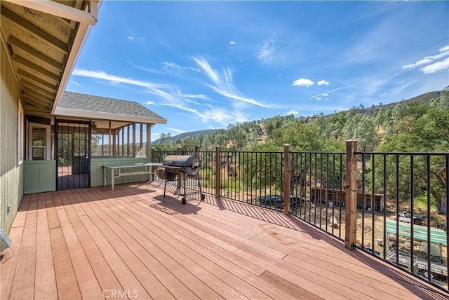 wooden terrace featuring a mountain view and grilling area