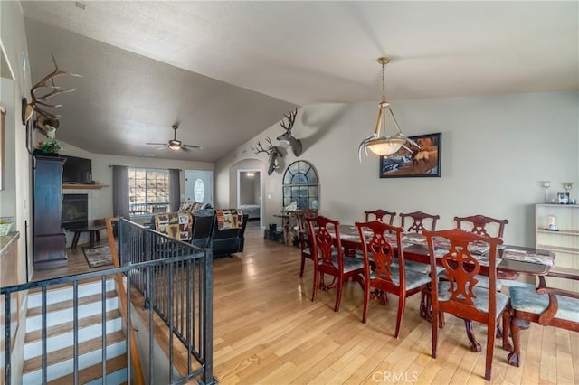 dining space with lofted ceiling, ceiling fan, and light hardwood / wood-style floors