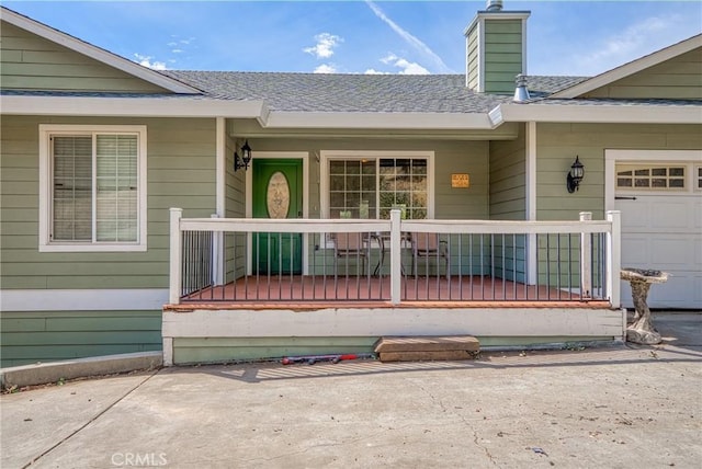 property entrance with covered porch and a garage