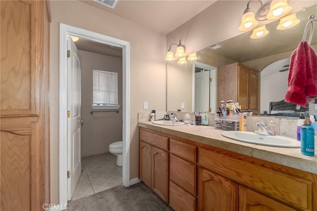 bathroom featuring tile patterned floors, toilet, and vanity