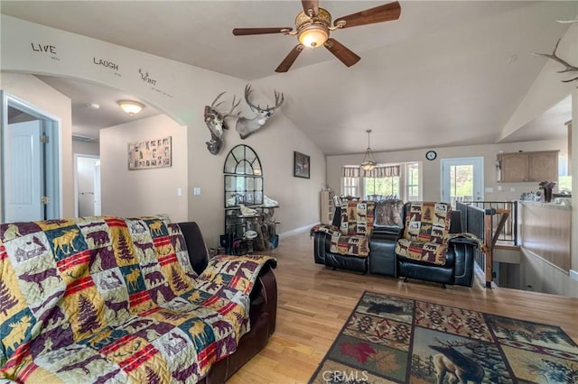 living room featuring ceiling fan, lofted ceiling, and light hardwood / wood-style floors