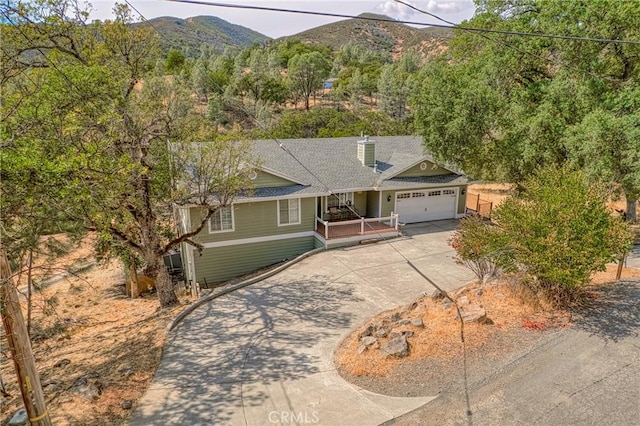 view of front of home with a mountain view and a garage