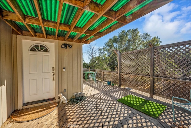 view of exterior entry with a wooden deck