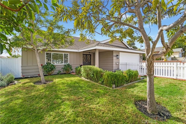 ranch-style home with a garage and a front lawn