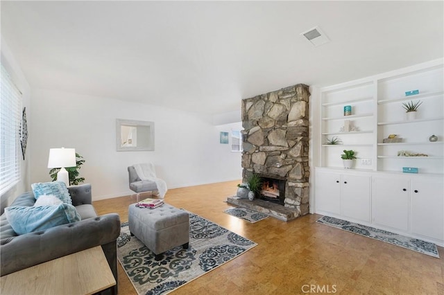 living room with plenty of natural light and a fireplace