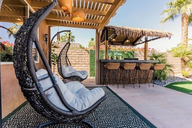 view of patio / terrace featuring exterior bar and a pergola