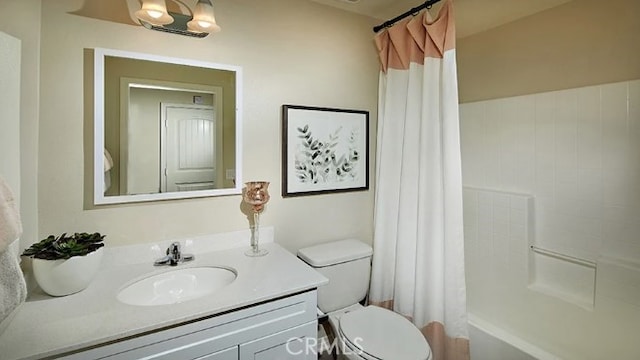 full bathroom featuring shower / bath combo with shower curtain, vanity, and toilet