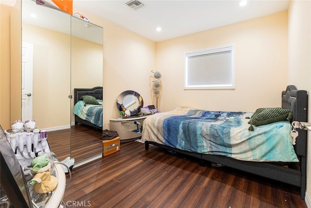 bedroom featuring dark hardwood / wood-style flooring