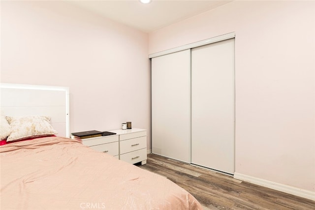 bedroom featuring a closet and dark wood-type flooring