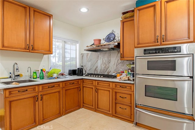 kitchen with light tile patterned floors, sink, stainless steel appliances, range hood, and decorative backsplash