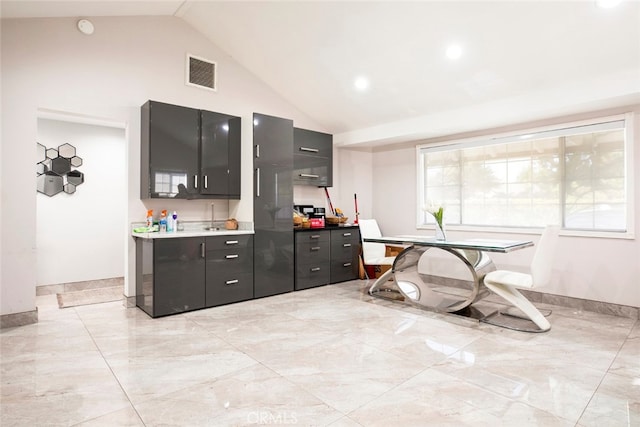 kitchen featuring high vaulted ceiling