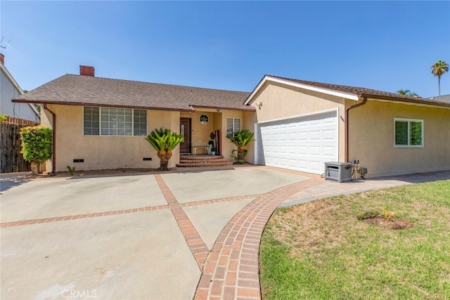 ranch-style house featuring a garage and a front yard