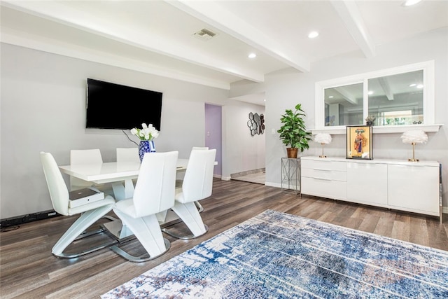 dining area featuring beamed ceiling and dark hardwood / wood-style flooring