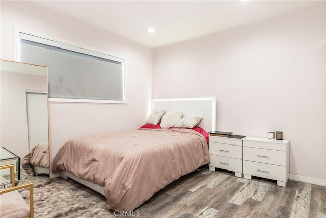 bedroom with hardwood / wood-style floors