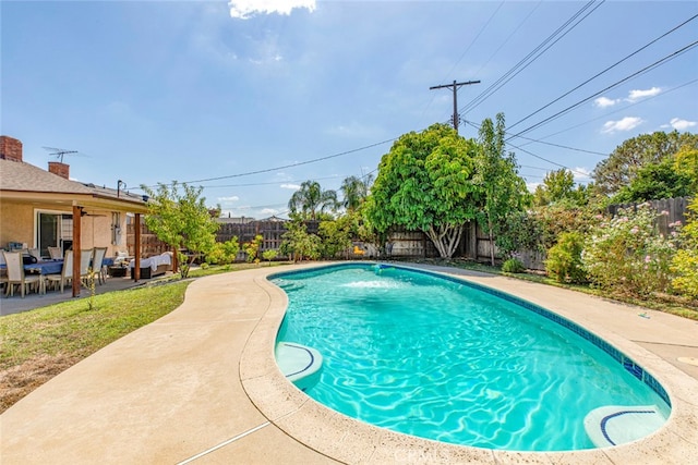 view of pool with pool water feature and a patio area