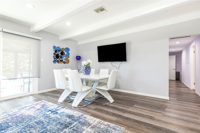 dining room with hardwood / wood-style flooring and beam ceiling