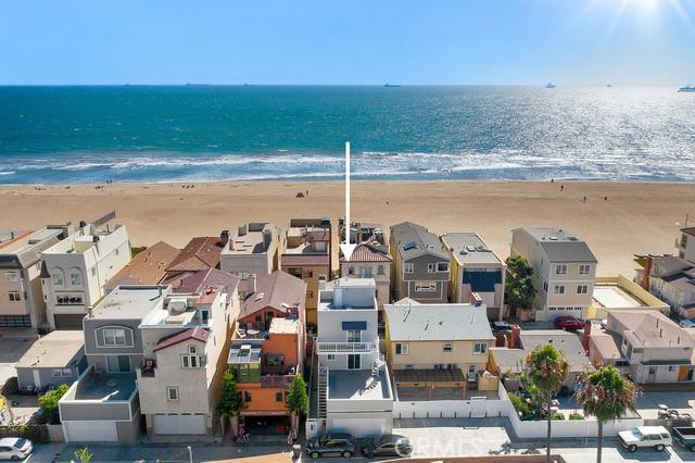 bird's eye view featuring a water view and a beach view