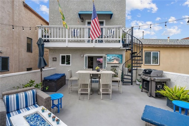 rear view of property with a balcony and a patio