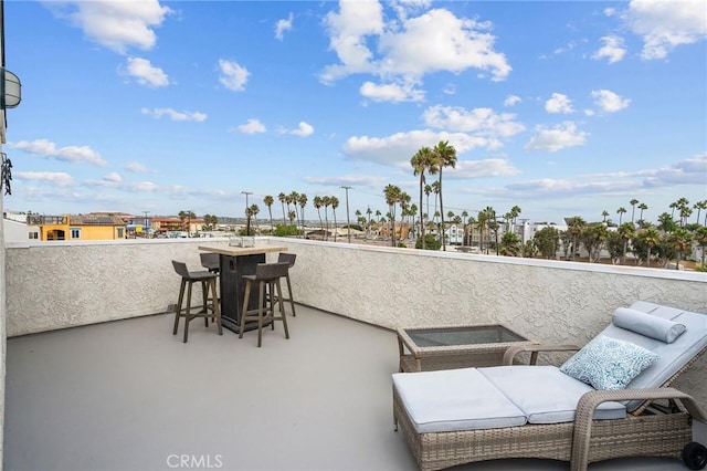 view of patio featuring a balcony