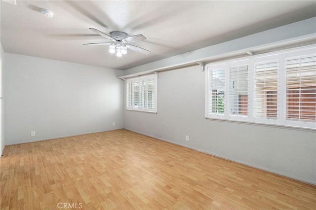 unfurnished room featuring light hardwood / wood-style flooring, plenty of natural light, and ceiling fan