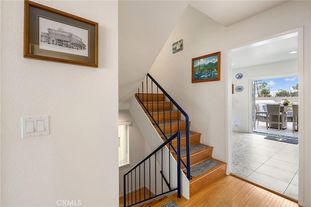 staircase with hardwood / wood-style flooring