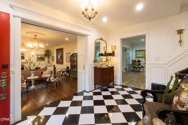 interior space featuring a notable chandelier, ornamental molding, and dark wood-type flooring