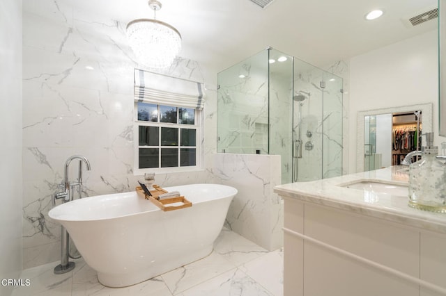 bathroom featuring shower with separate bathtub, vanity, and tile walls