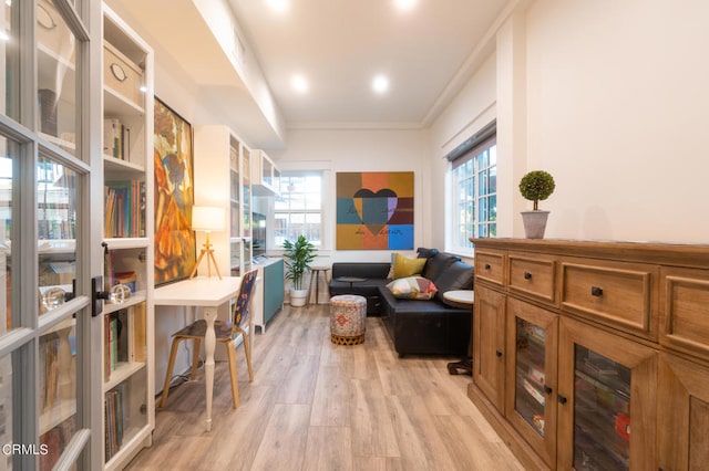 sitting room featuring light hardwood / wood-style floors and ornamental molding