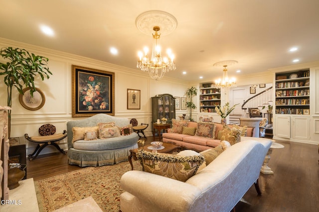 living room with built in features, a chandelier, crown molding, and dark hardwood / wood-style flooring