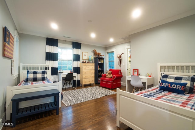 bedroom with dark hardwood / wood-style floors and crown molding